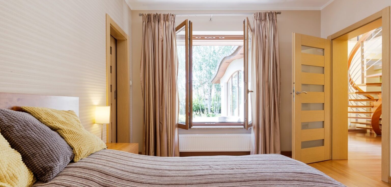 Bedroom interior with open window Bedroom interior with open window, marital bed and entry to staircase